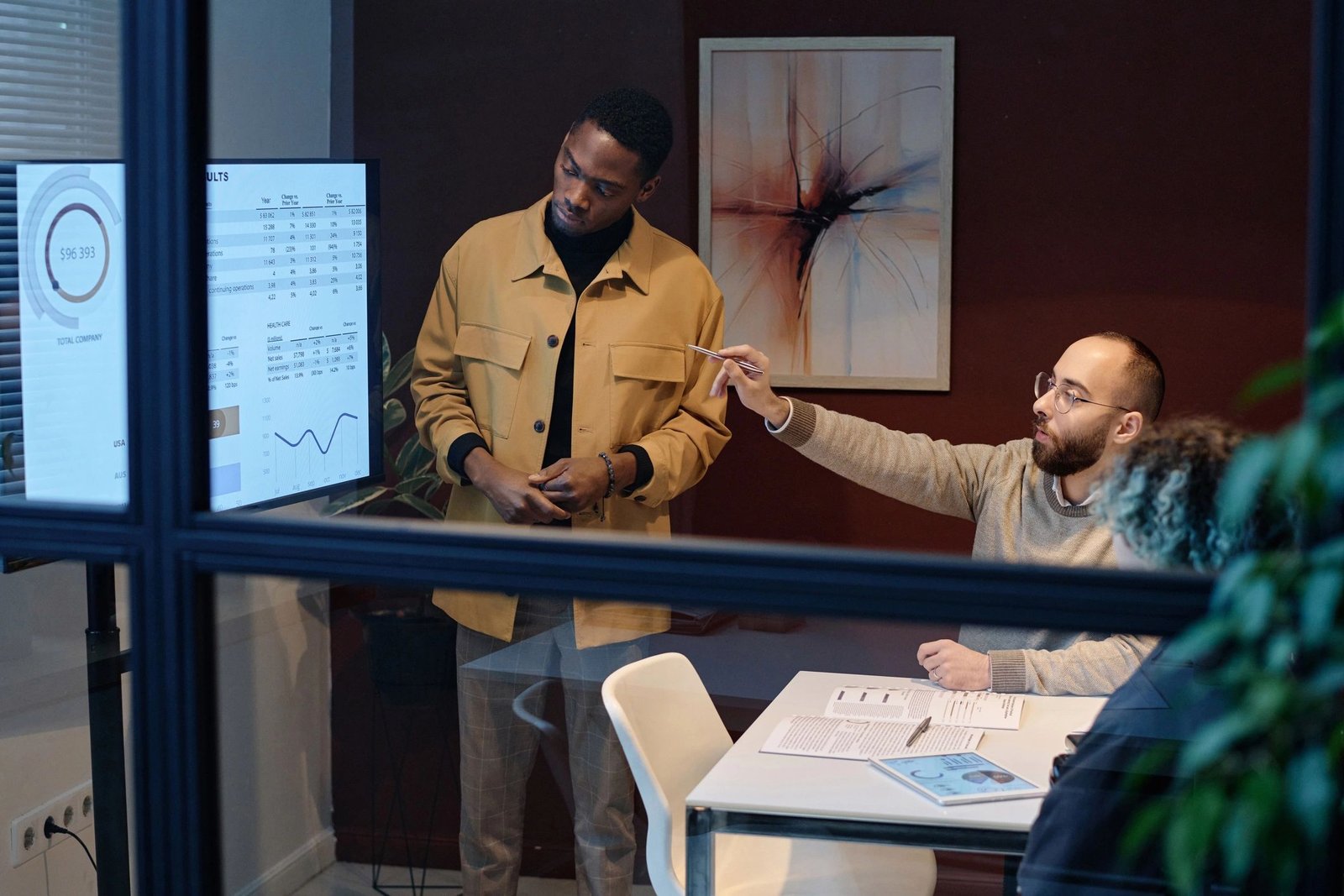 IT consulting team reviewing technology dashboards in a conference room