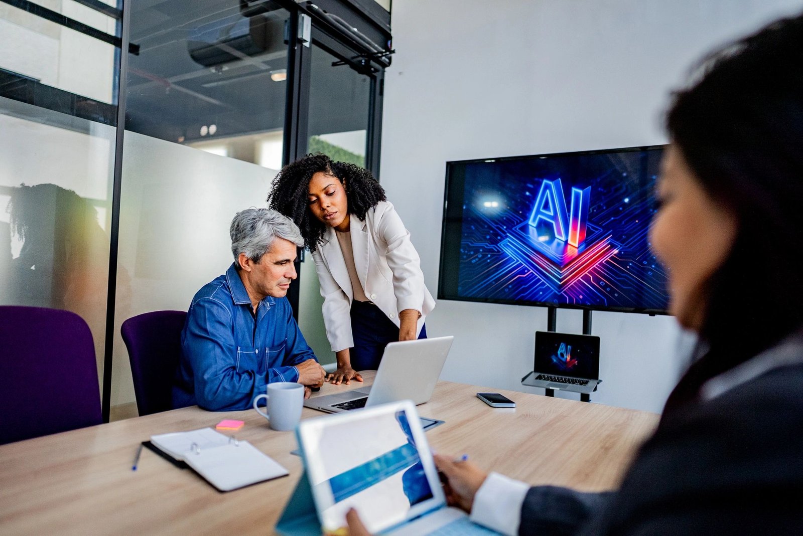 Coworkers discussing a technology project during a business meeting